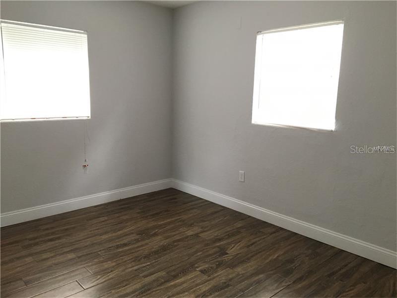 508 Varsity Street Winter Garden, FL 34787 - Photo 5 of 10 an empty room with wooden floor and a window