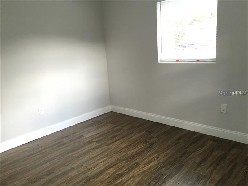 508 Varsity Street Winter Garden, FL 34787 - Photo 6 of 10 an empty room with wooden floor and windows