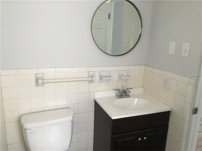 508 Varsity Street Winter Garden, FL 34787 - Photo 7 of 10 a bathroom with a toilet a sink and mirror