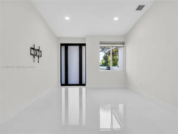 a view of an entryway with wooden floor