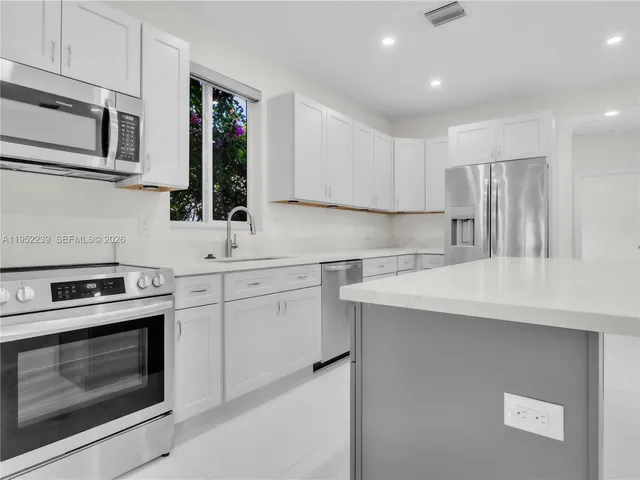 a kitchen with a sink stove and microwave