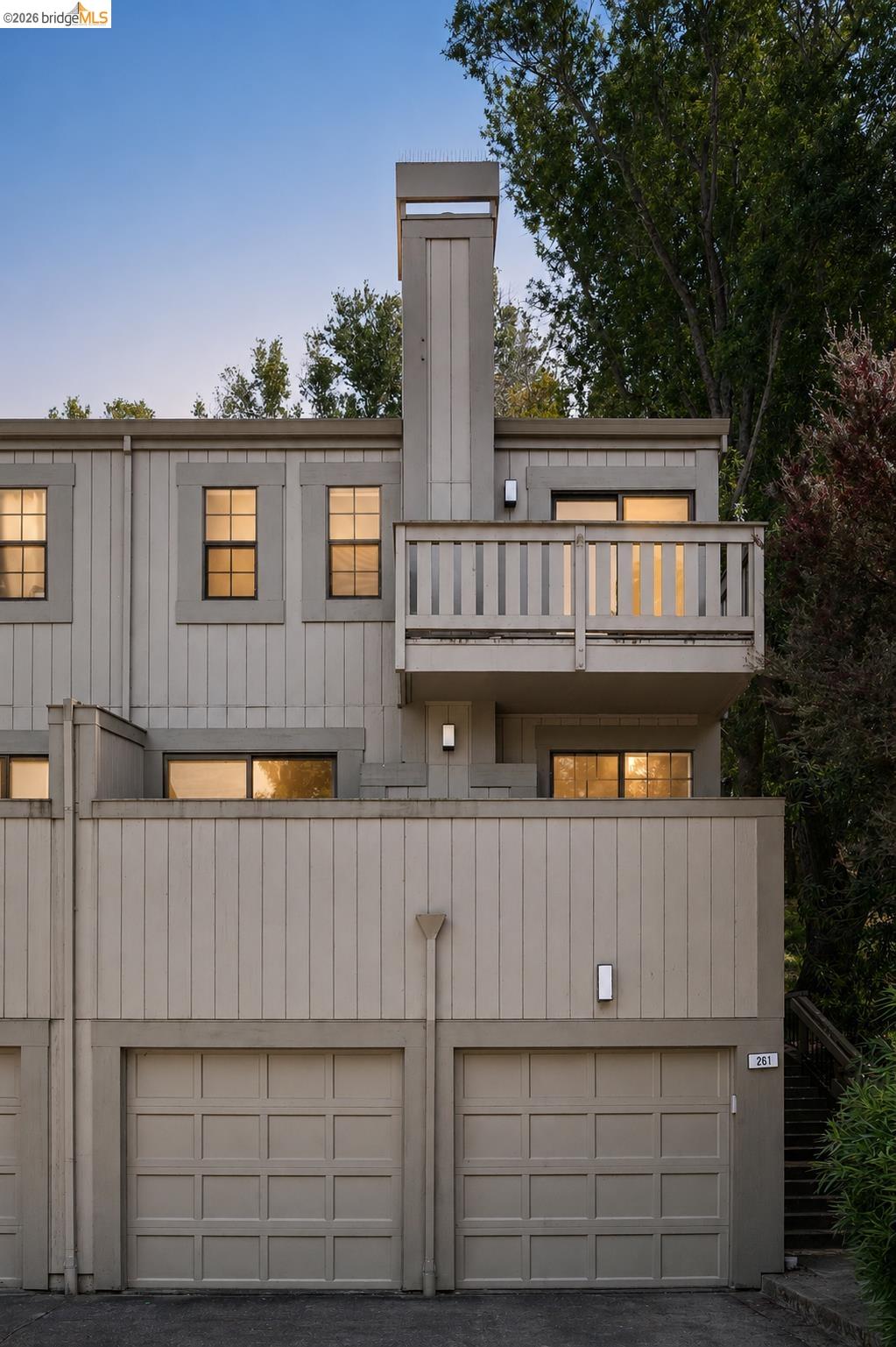 261 Redhawk Road Novato, CA 94949 - Photo 7 of 44 Multi-level exterior featuring a private balcony with wood railing, two single-car garages, and recessed windows
