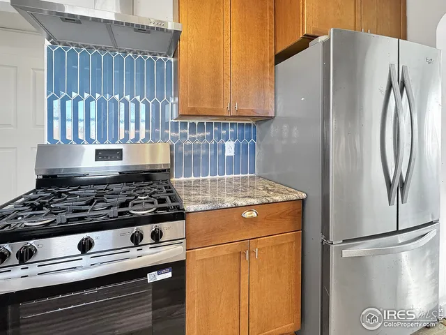 a kitchen with a stove and a refrigerator