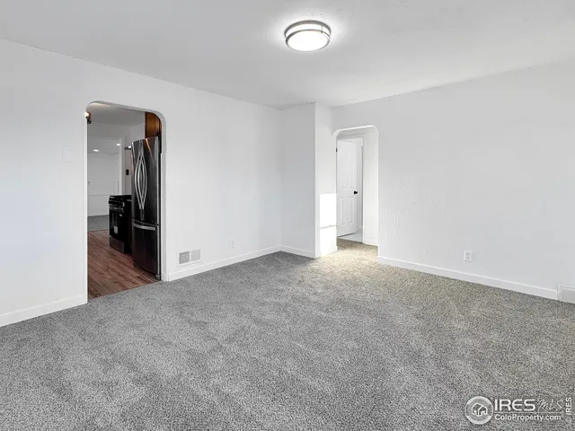 an empty room with closet and wooden floor