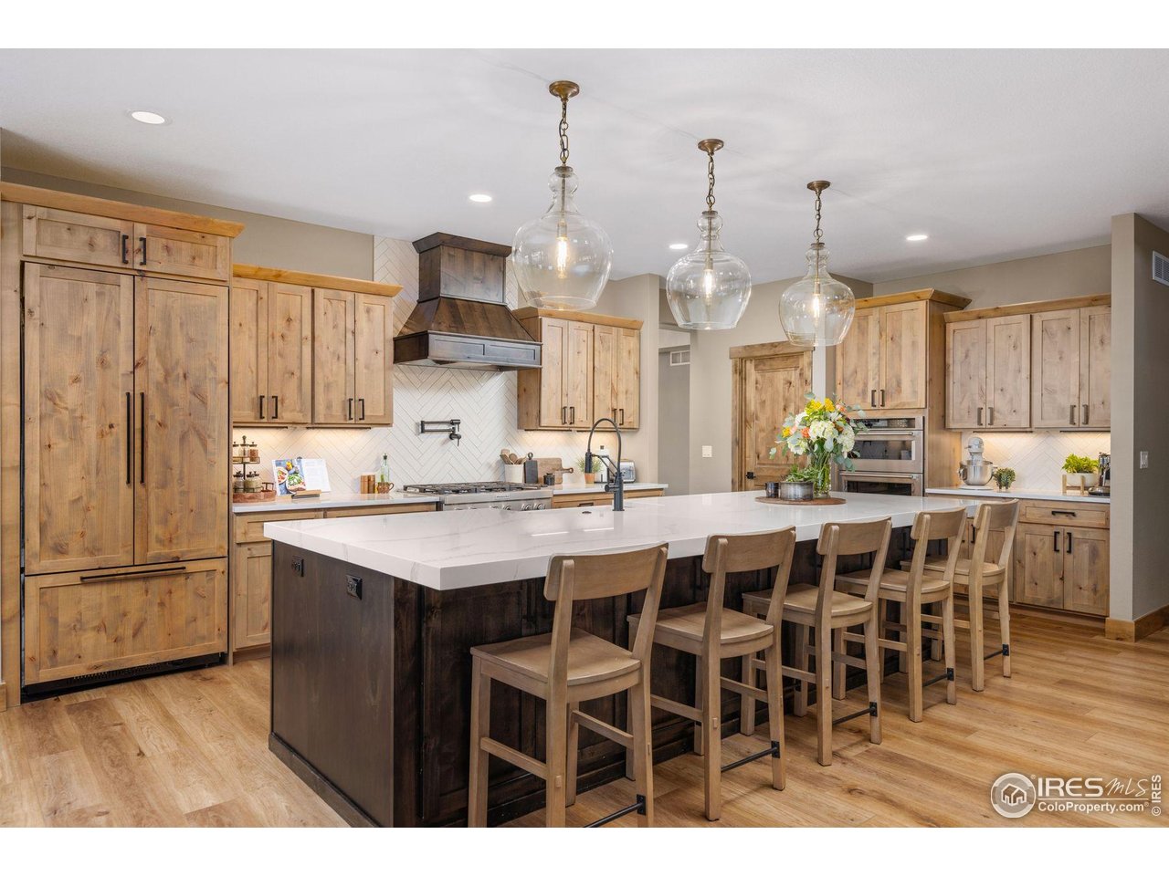 2734 Southwind Road Berthoud, CO 80513 - Photo 12 of 50 Welcoming Chef's Kitchen with Under-Cabinet Lighting, Custom Hood, and Walk-In Pantry