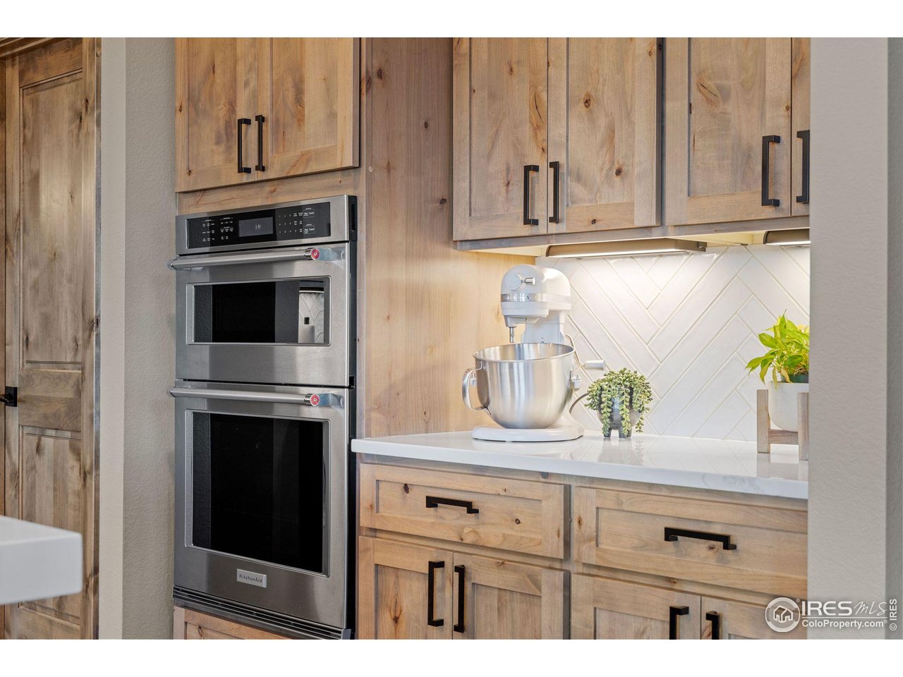 2734 Southwind Road Berthoud, CO 80513 - Photo 14 of 50 Knotty Alder Cabinetry Throughout the Kitchen