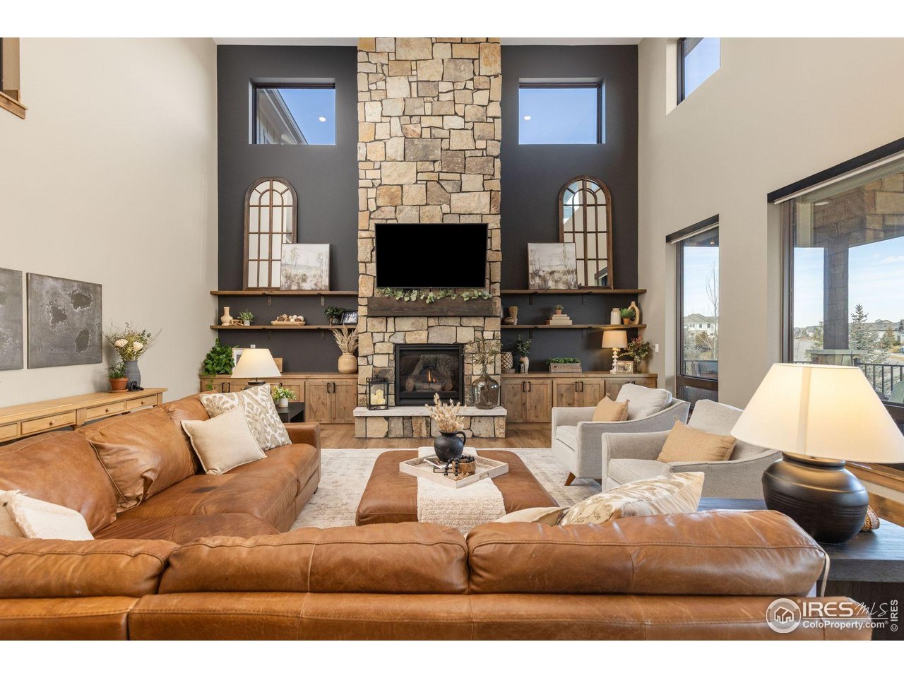 2734 Southwind Road Berthoud, CO 80513 - Photo 2 of 50 Stacked Fireplace with Hearth and Mantle, Built-in Cabinets, and Custom Floating Shelves