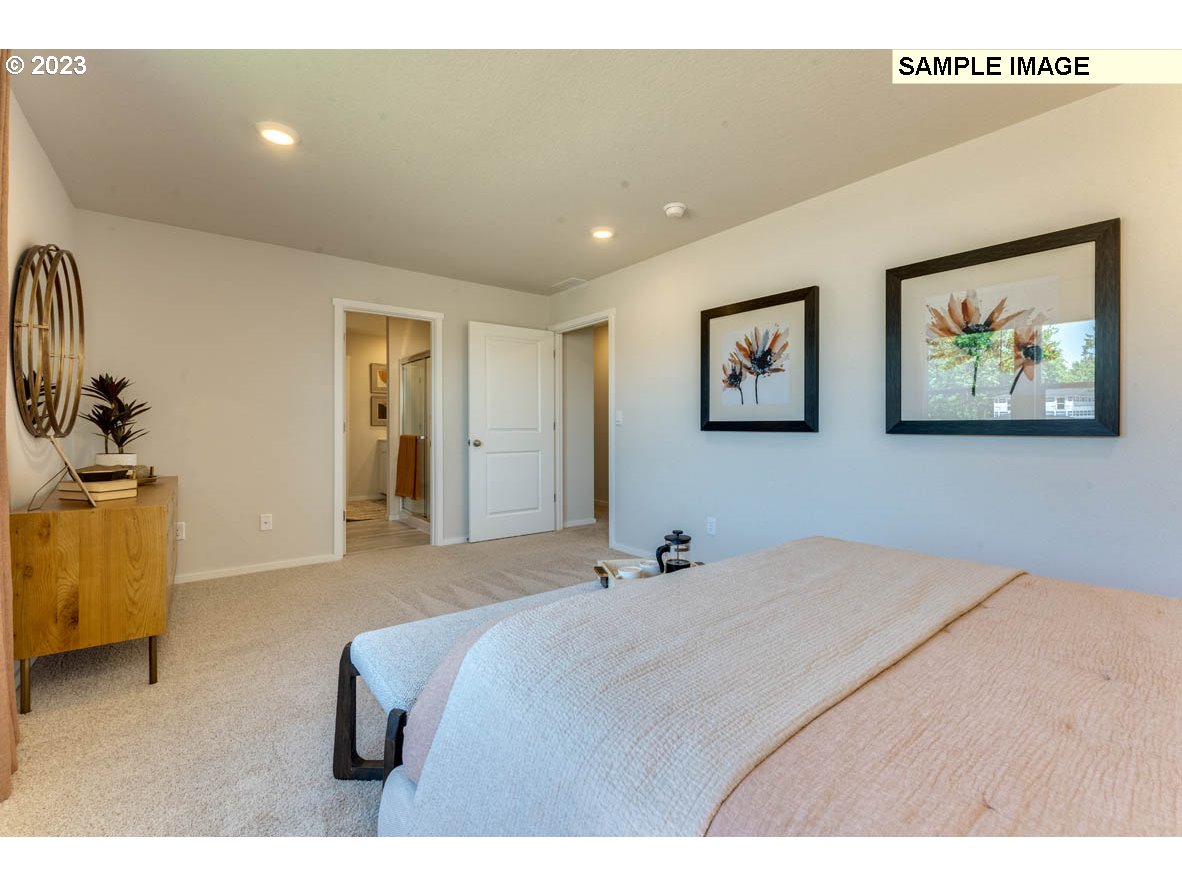 141 Cedar Springs Loop North Kalama, WA 98625 - Photo 28 of 31 a bedroom with a bed and painting on the wall