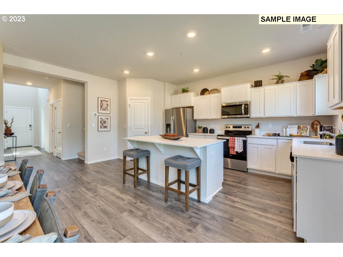 141 Cedar Springs Loop North Kalama, WA 98625 - Photo 7 of 31 a open kitchen with cabinets a sink and appliances