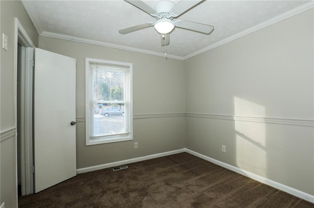206 Emily Drive Dallas, GA 30157 - Photo 11 of 17 an empty room with a window and a fan