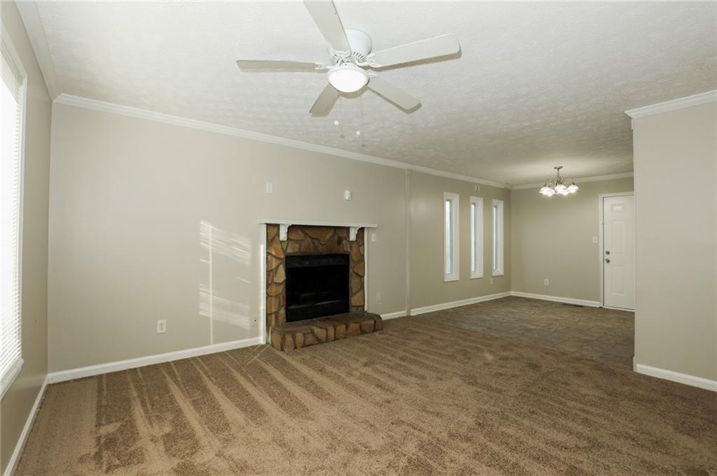 206 Emily Drive Dallas, GA 30157 - Photo 3 of 17 an empty room with windows and fan