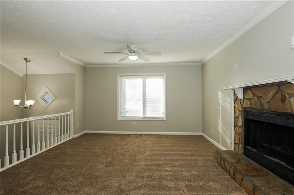 206 Emily Drive Dallas, GA 30157 - Photo 5 of 17 a view of an empty room with wooden floor fireplace and a window