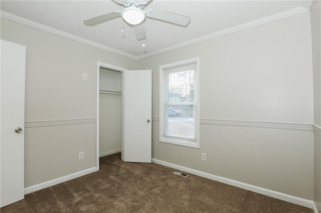 206 Emily Drive Dallas, GA 30157 - Photo 9 of 17 an empty room with windows and fan