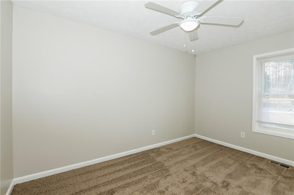 206 Emily Drive Dallas, GA 30157 - Photo 10 of 17 an empty room with a window and a fan