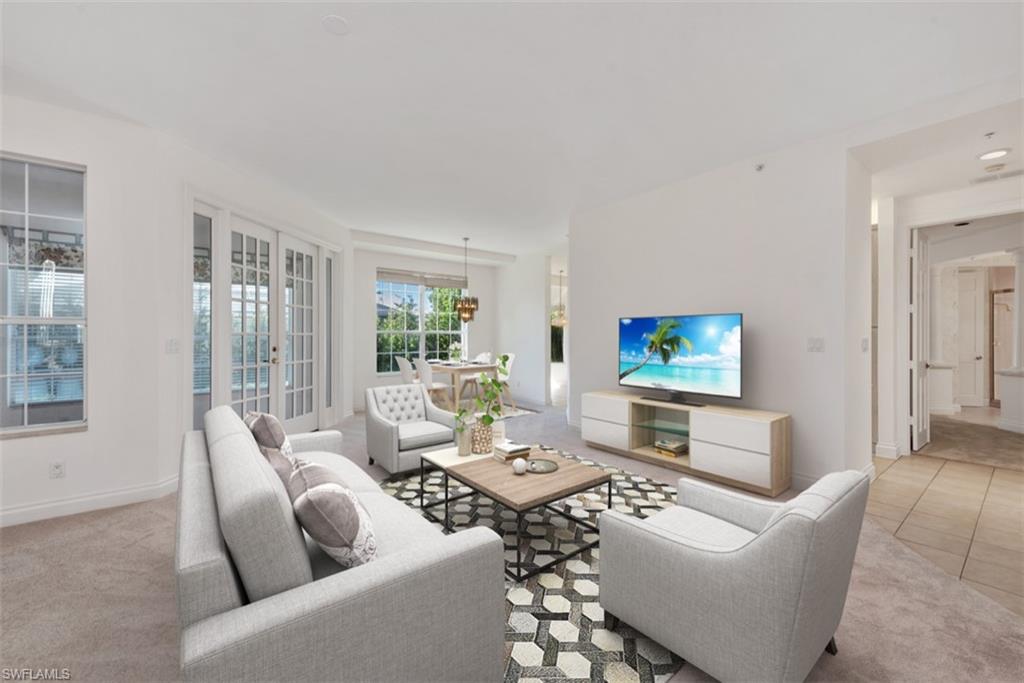 133 Colonade Circle Naples, FL 34103 - Photo 1 of 24 a living room with furniture a large window and a flat screen tv