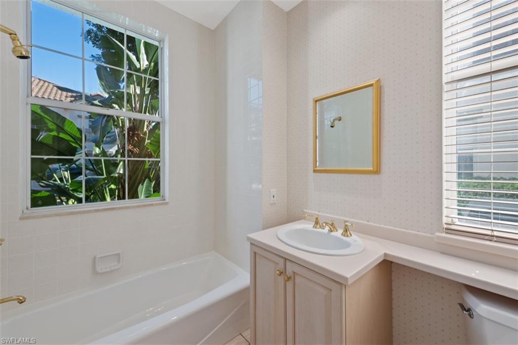 133 Colonade Circle Naples, FL 34103 - Photo 12 of 24 a bathroom with a sink and a bathtub