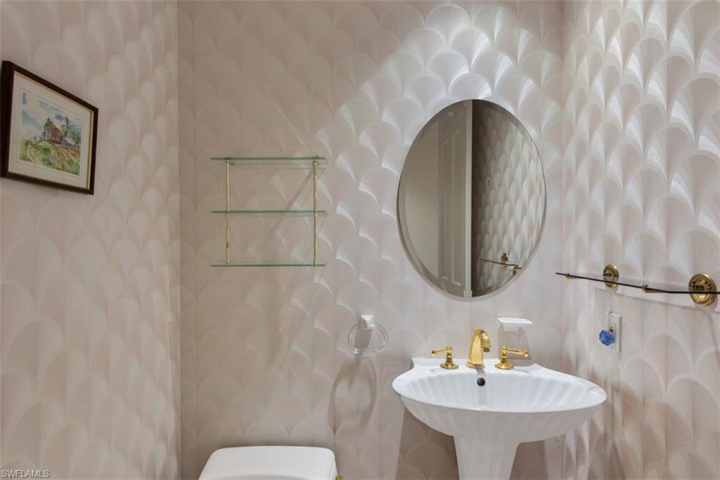 133 Colonade Circle Naples, FL 34103 - Photo 14 of 24 a bathroom with a sink and a mirror