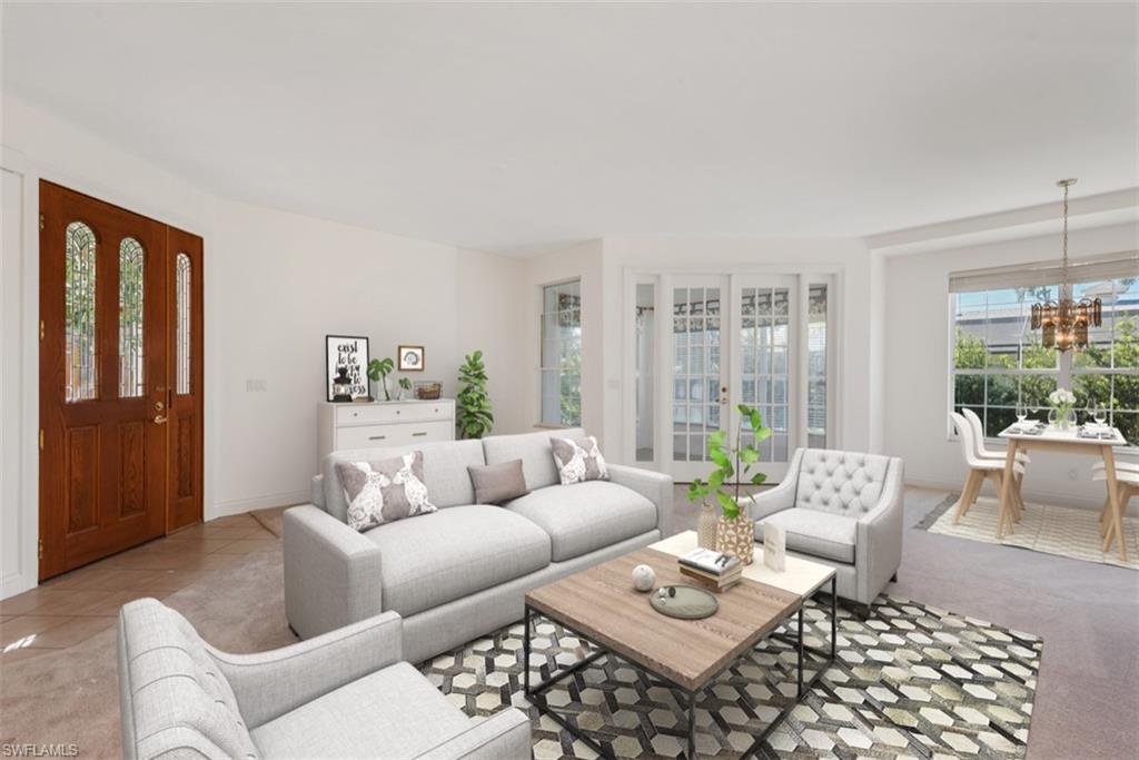 133 Colonade Circle Naples, FL 34103 - Photo 2 of 24 a living room with furniture and a large window