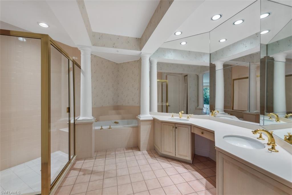 133 Colonade Circle Naples, FL 34103 - Photo 10 of 24 a bathroom with a sink a toilet and mirror