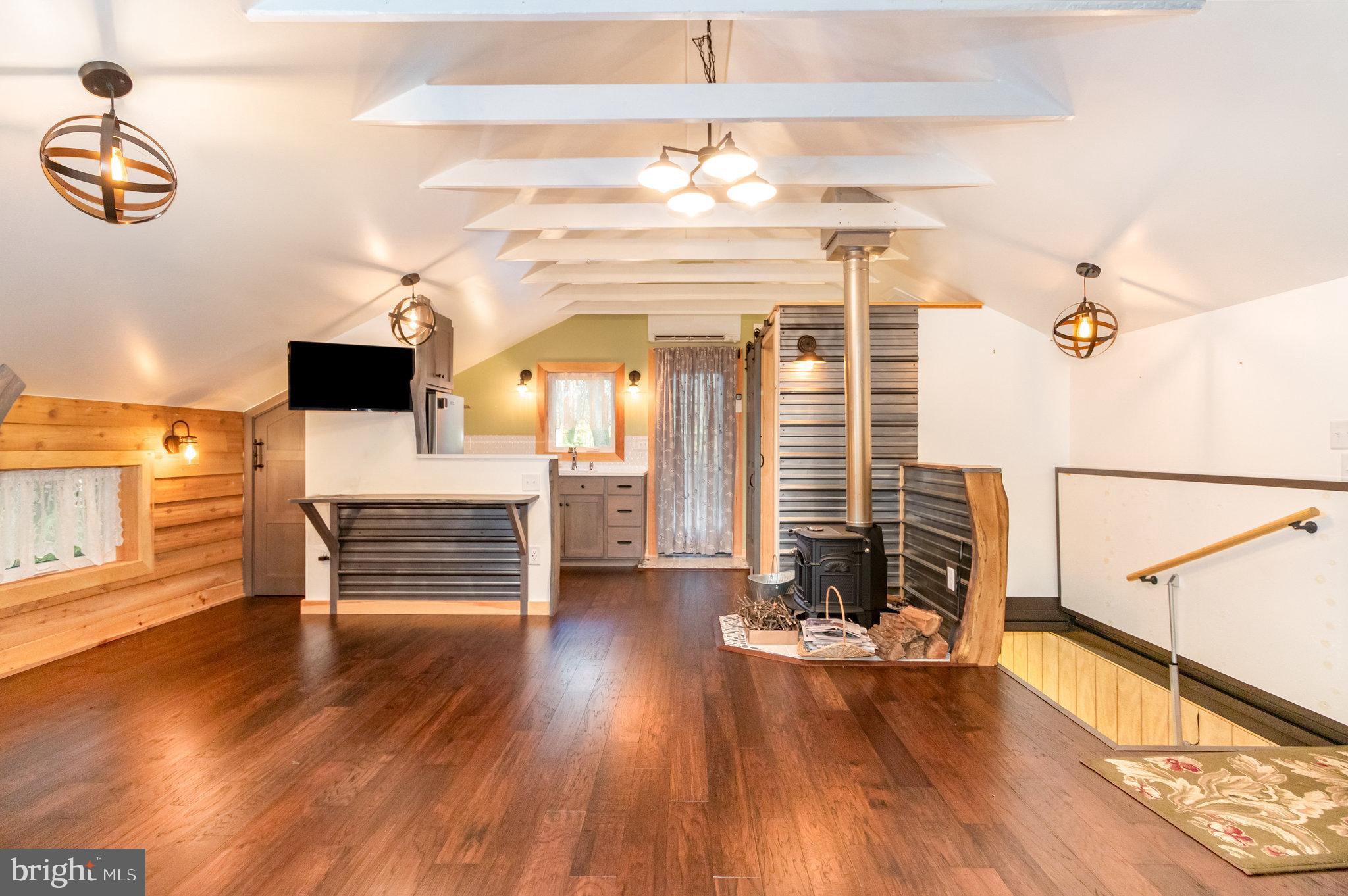 1327 Baltimore Road Shippensburg, PA 17257 - Photo 38 of 57 an empty room with wooden floor and windows