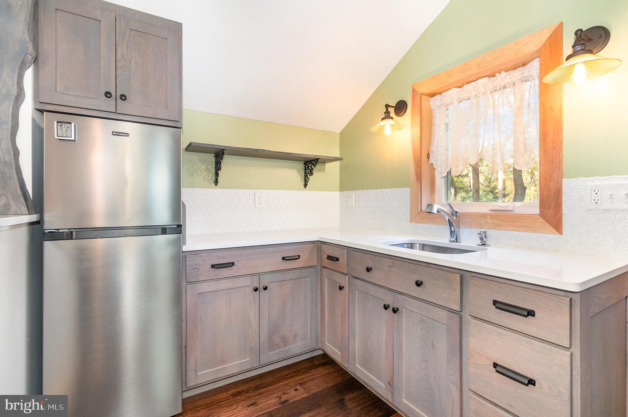1327 Baltimore Road Shippensburg, PA 17257 - Photo 39 of 57 a kitchen with a refrigerator sink and cabinets