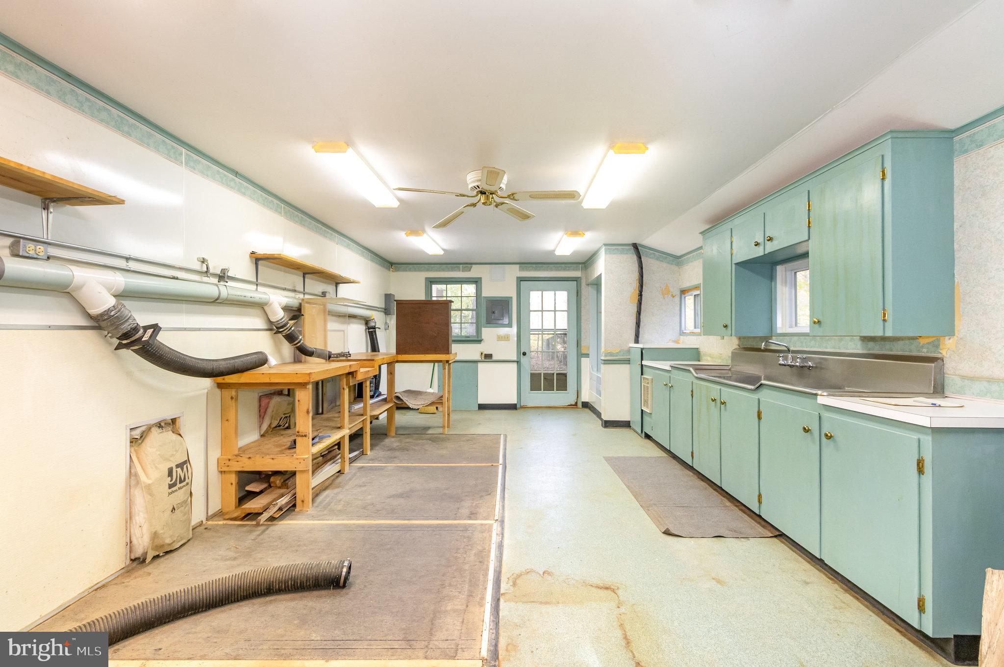 1327 Baltimore Road Shippensburg, PA 17257 - Photo 42 of 57 a large white kitchen with lots of counter space and a sink