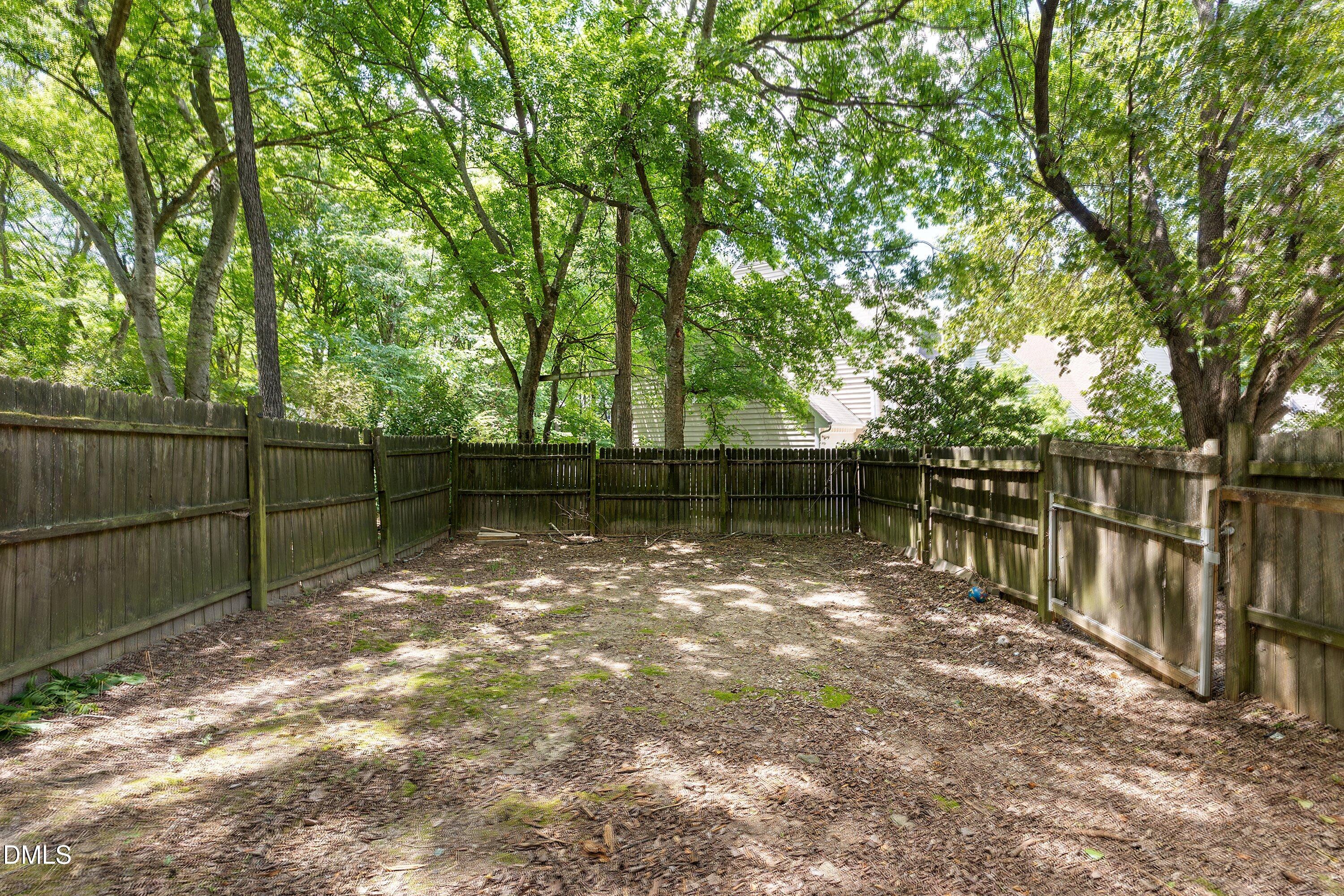 2517 Birchford Court Raleigh, NC 27604 - Photo 57 of 63 a backyard of a house with large trees