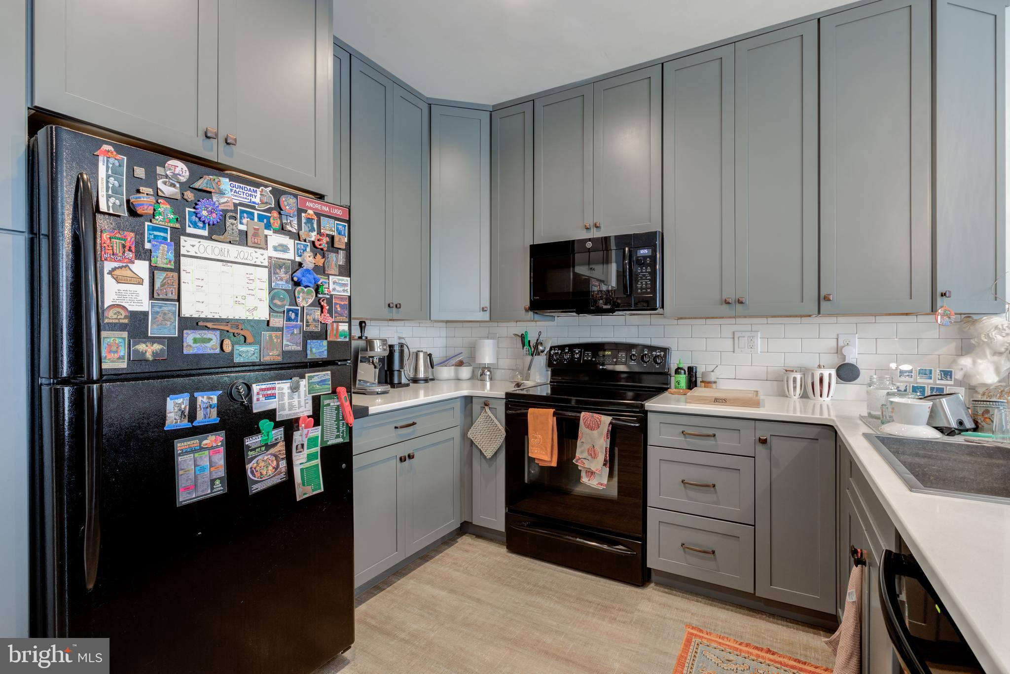 134 Bridge Street, Unit 201 Phoenixville, PA 19460 - Photo 16 of 33 a kitchen with stainless steel appliances a stove refrigerator and a sink