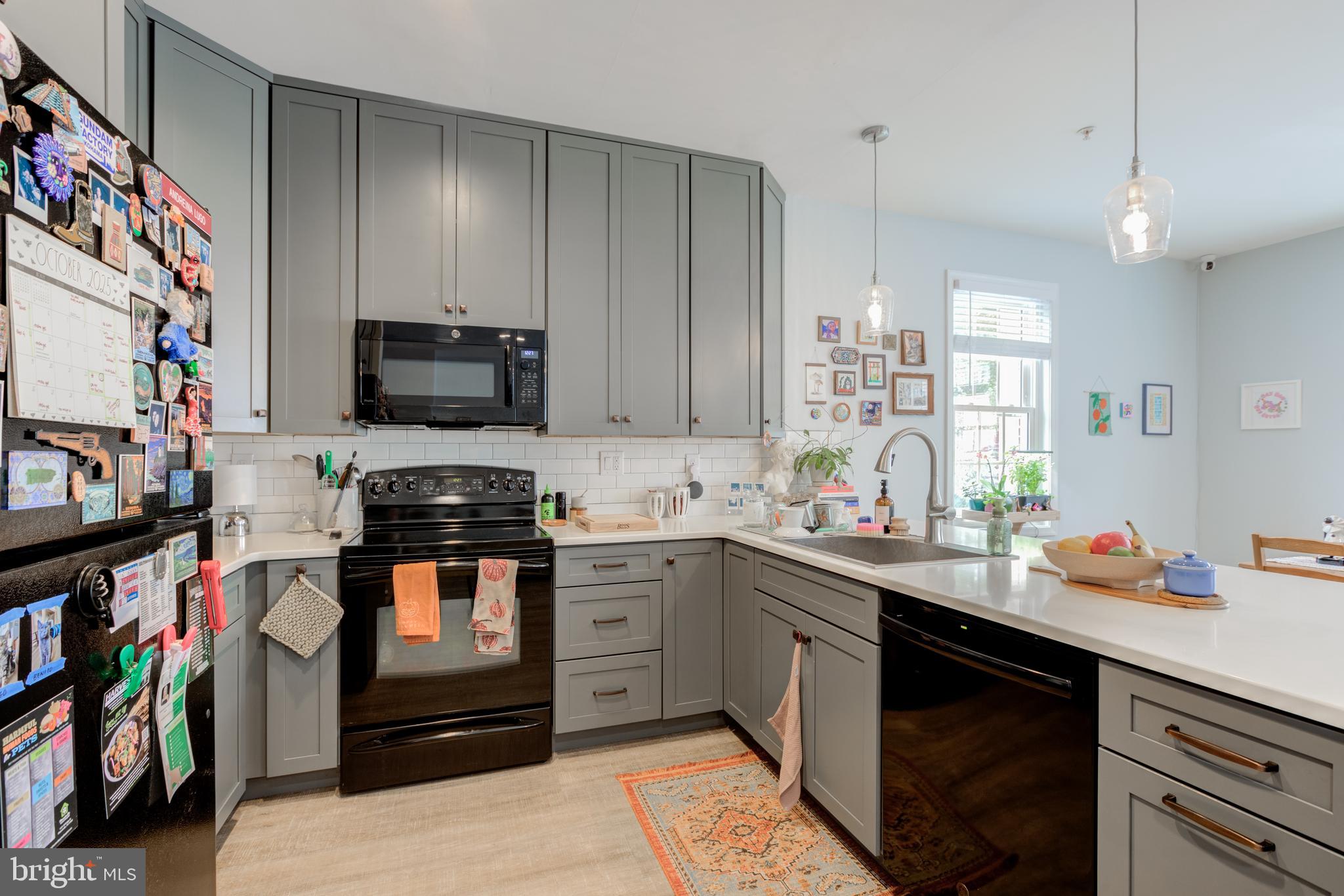 134 Bridge Street, Unit 201 Phoenixville, PA 19460 - Photo 17 of 33 a kitchen with stainless steel appliances a sink dishwasher a stove and a refrigerator