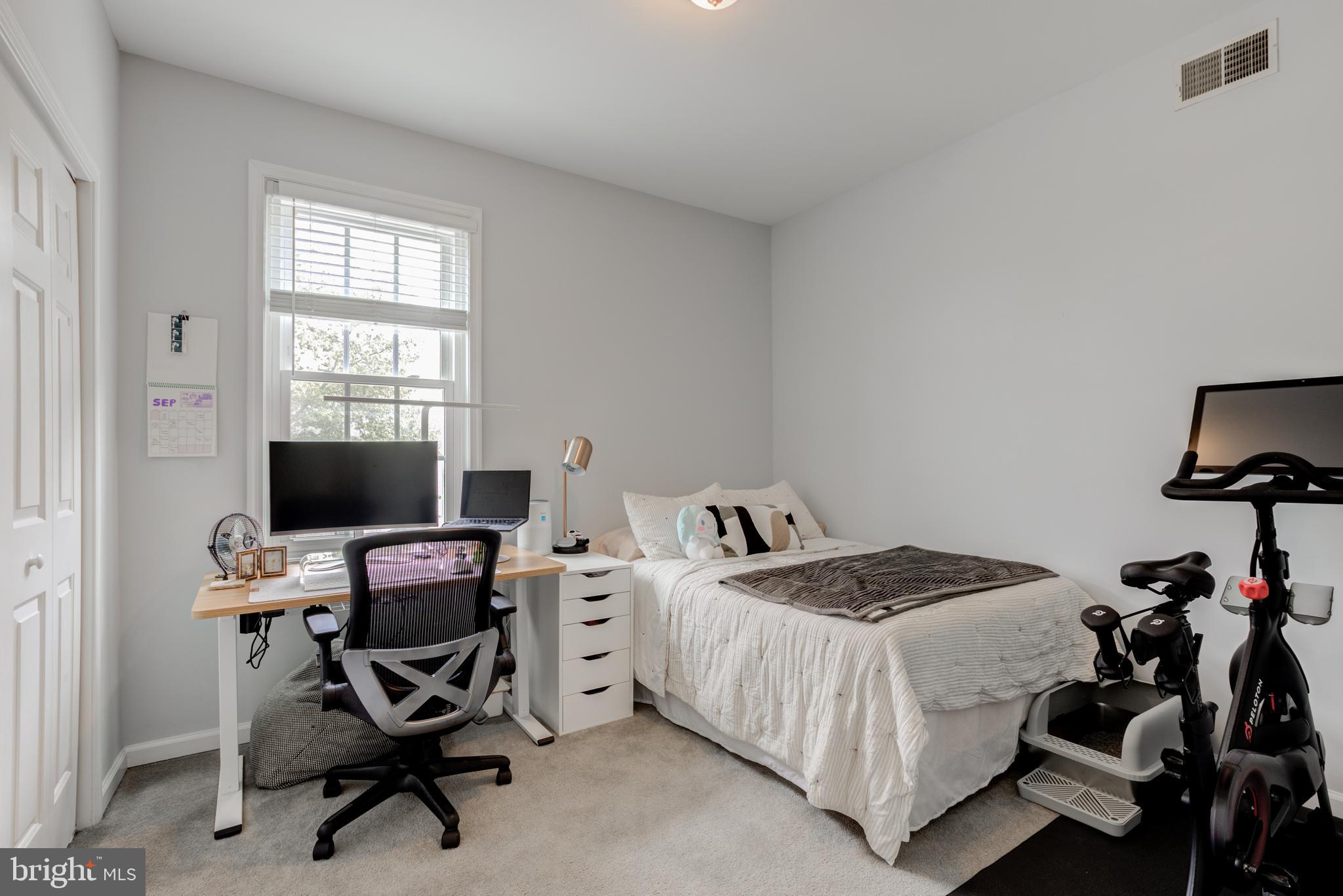 134 Bridge Street, Unit 201 Phoenixville, PA 19460 - Photo 28 of 33 a bedroom with a bed and a computer on a desk