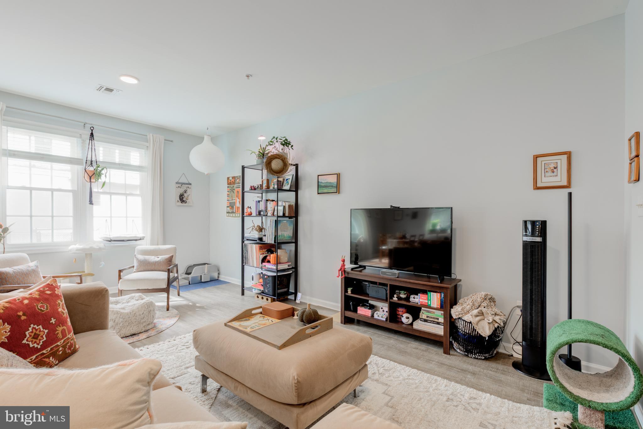 134 Bridge Street, Unit 201 Phoenixville, PA 19460 - Photo 6 of 33 a living room with furniture and a flat screen tv