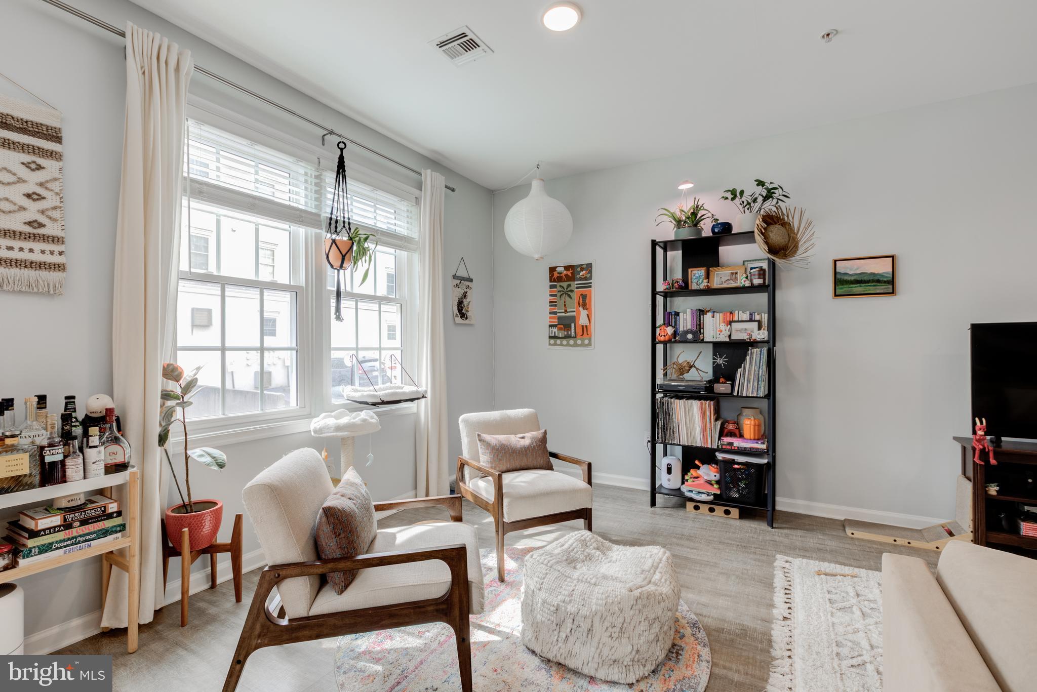 134 Bridge Street, Unit 201 Phoenixville, PA 19460 - Photo 8 of 33 a living room with furniture cabinets and a flat screen tv