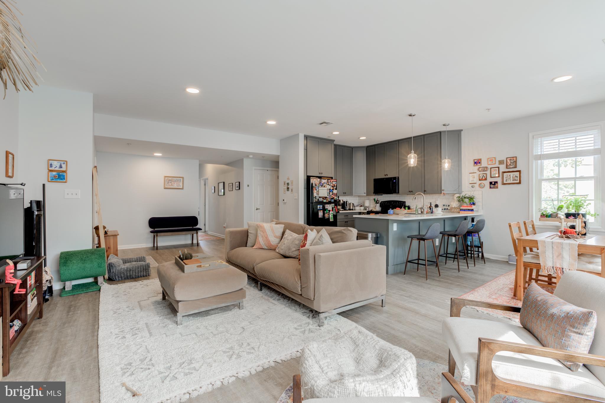 134 Bridge Street, Unit 201 Phoenixville, PA 19460 - Photo 9 of 33 a living room with lots of furniture and a view of kitchen