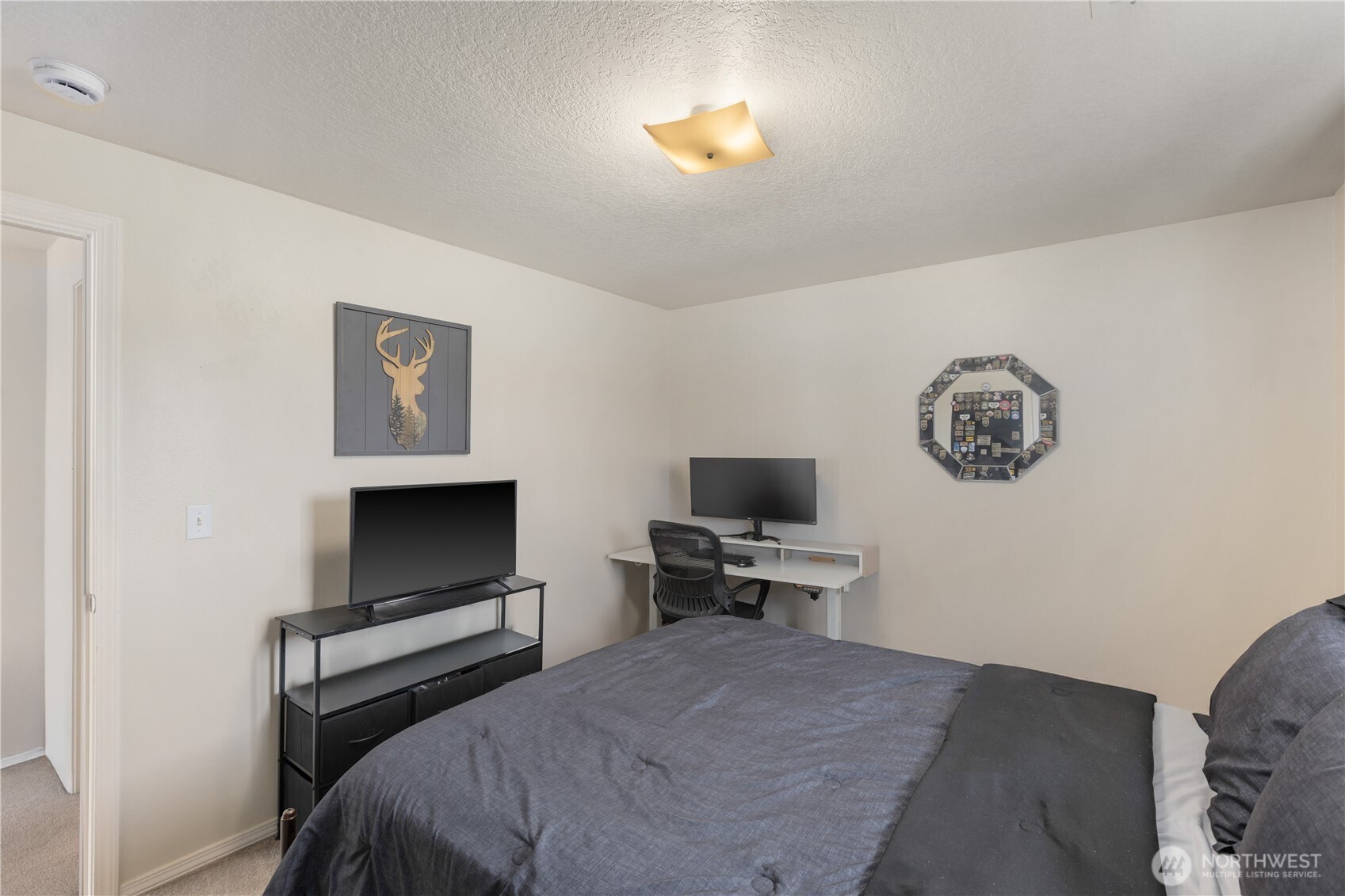 8305 Sweetbrier Loop Southeast Olympia, WA 98513 - Photo 29 of 40 a bedroom with a bed and a flat screen tv