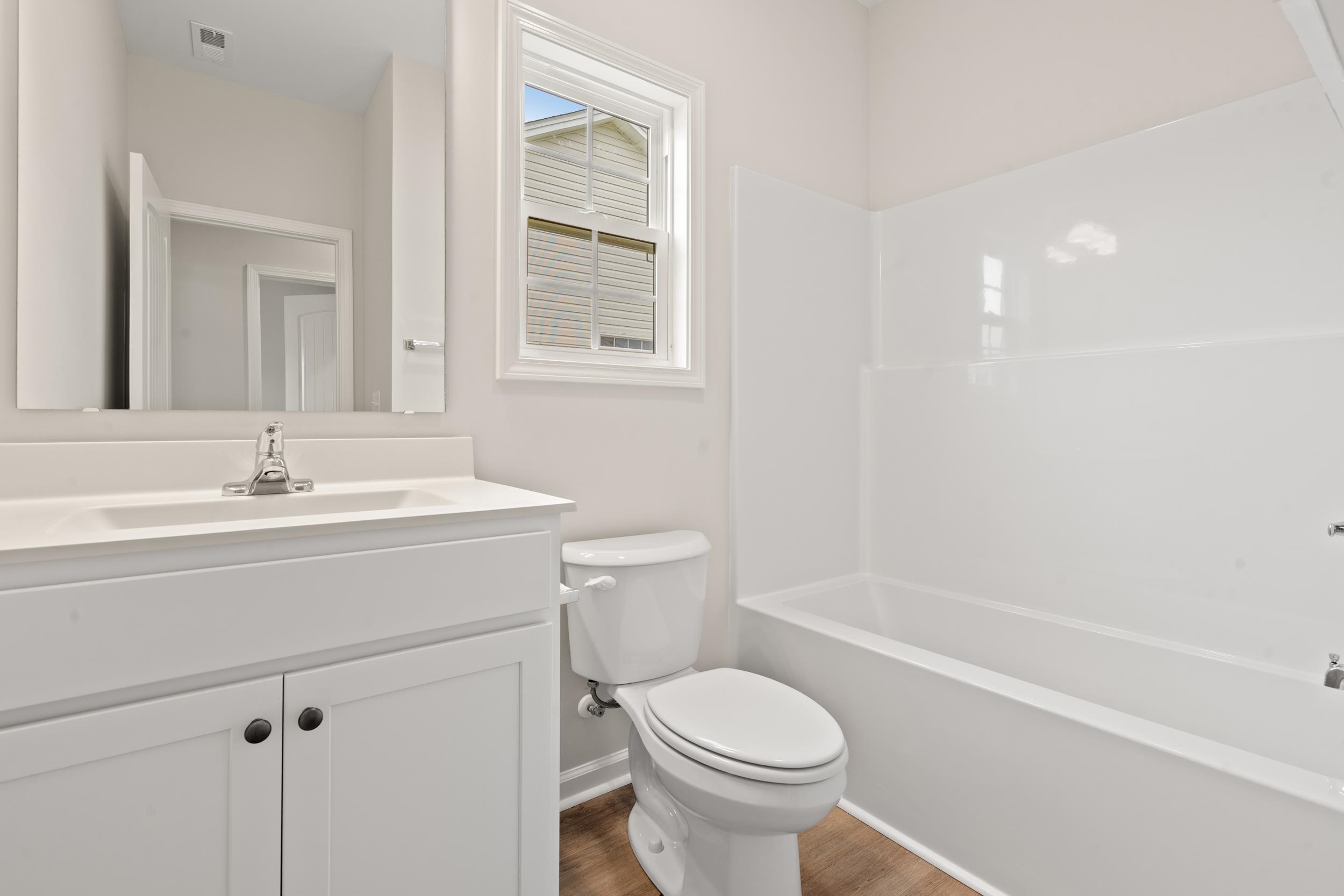 219 Stillbrook Drive Longs, SC 29568 - Photo 16 of 33 Full bathroom with vanity, shower combination, and dark wood finished floors