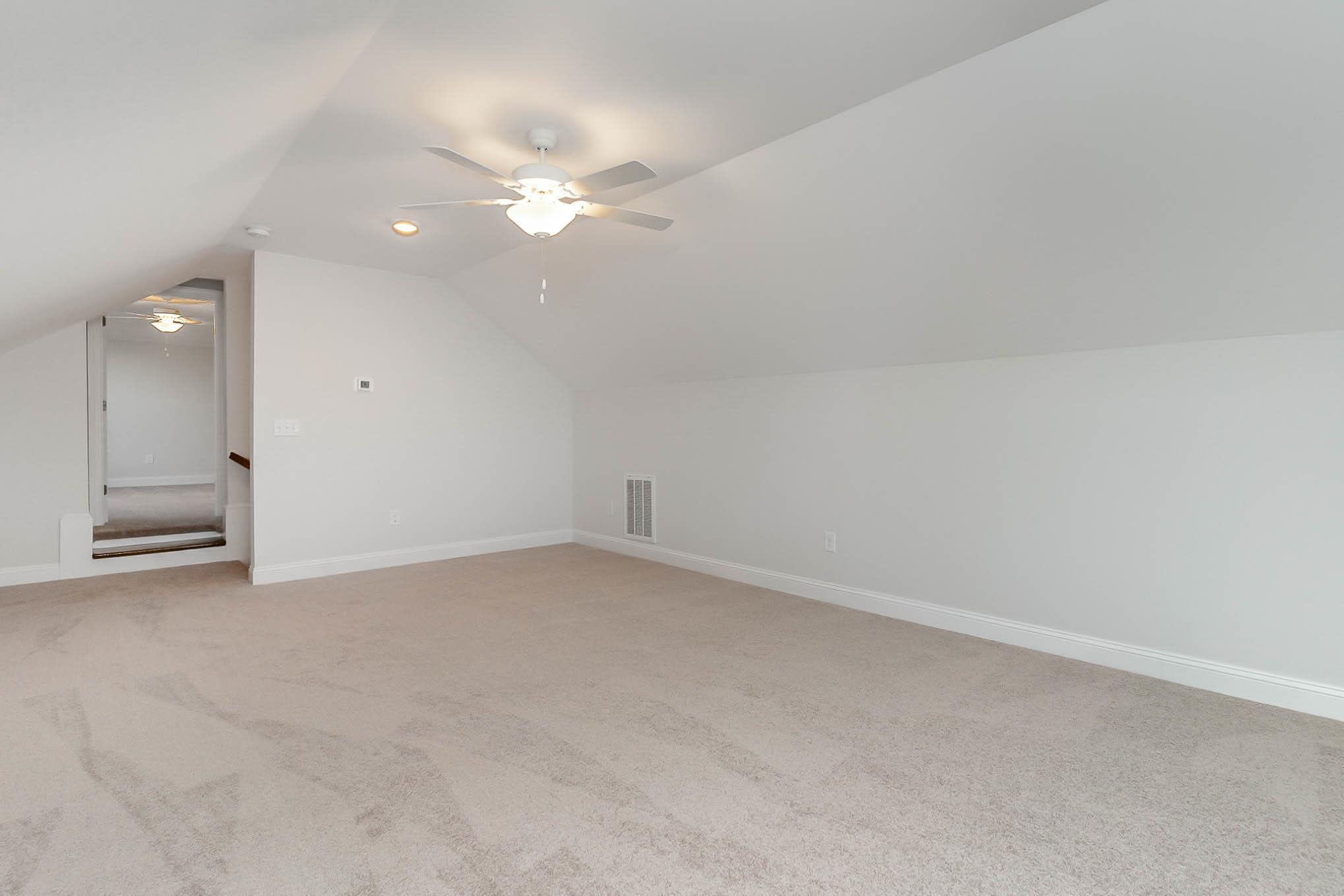 219 Stillbrook Drive Longs, SC 29568 - Photo 18 of 33 Bonus room featuring light carpet, ceiling fan, and vaulted ceiling