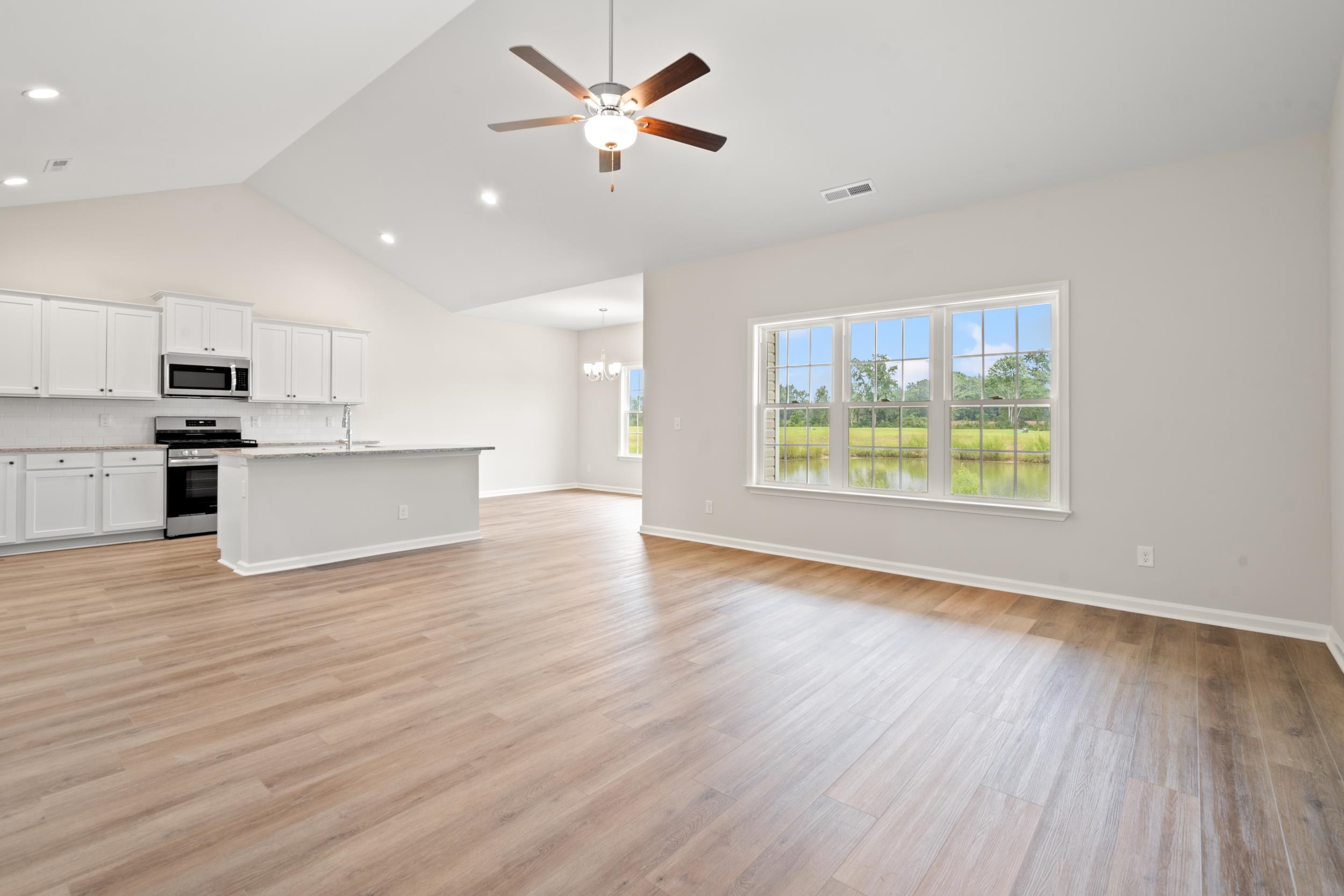 219 Stillbrook Drive Longs, SC 29568 - Photo 33 of 33 Kitchen with white cabinetry, open floor plan, stainless steel appliances, light wood-type flooring, and a ceiling fan