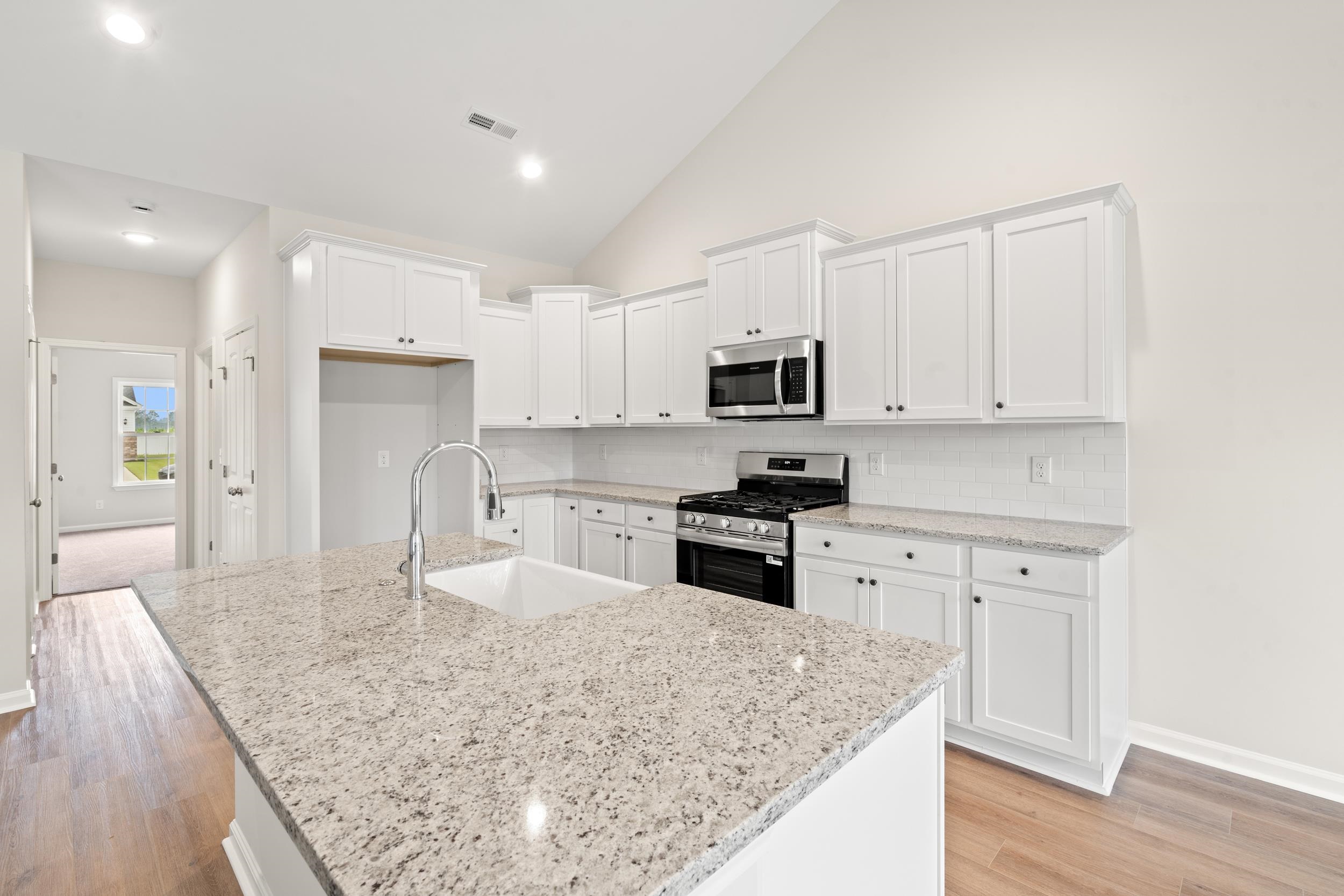 219 Stillbrook Drive Longs, SC 29568 - Photo 2 of 33 Kitchen featuring white cabinetry, stainless steel appliances, light stone countertops, tasteful backsplash, and recessed lighting