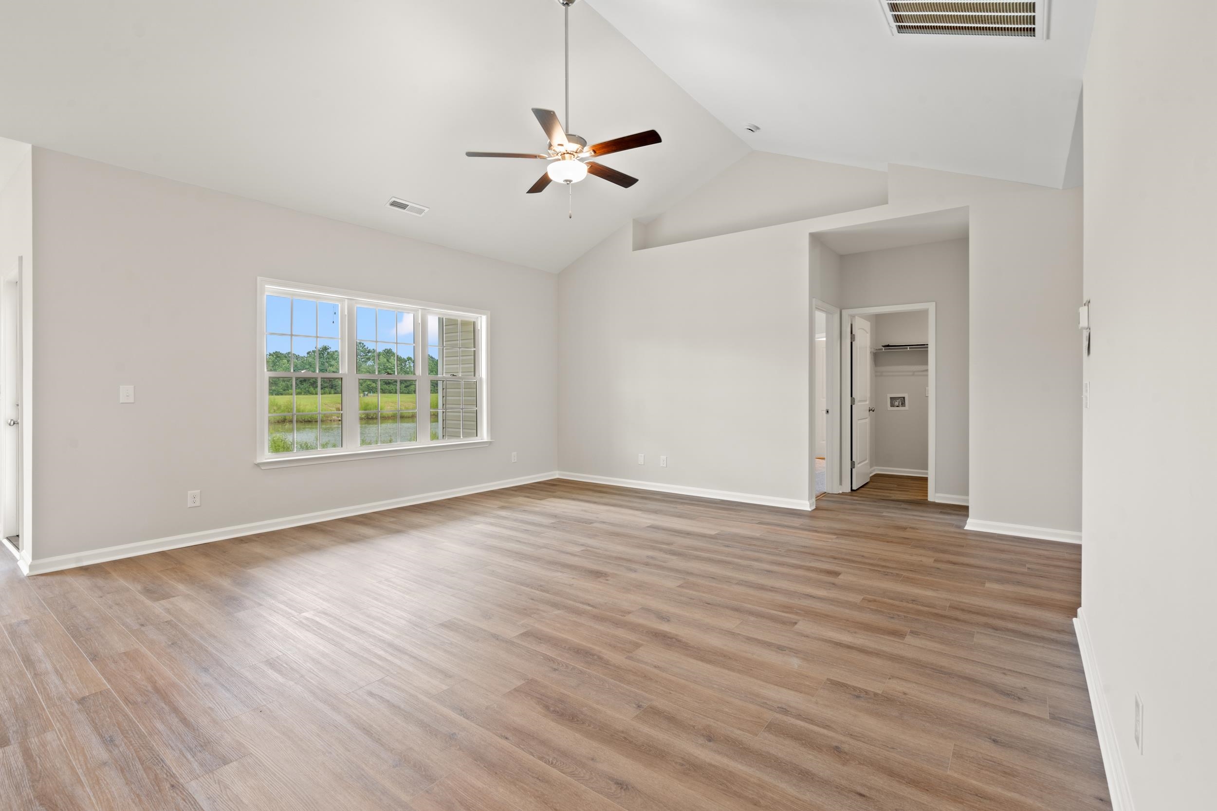 219 Stillbrook Drive Longs, SC 29568 - Photo 5 of 33 Unfurnished room featuring light wood-style floors, a ceiling fan, and high vaulted ceiling