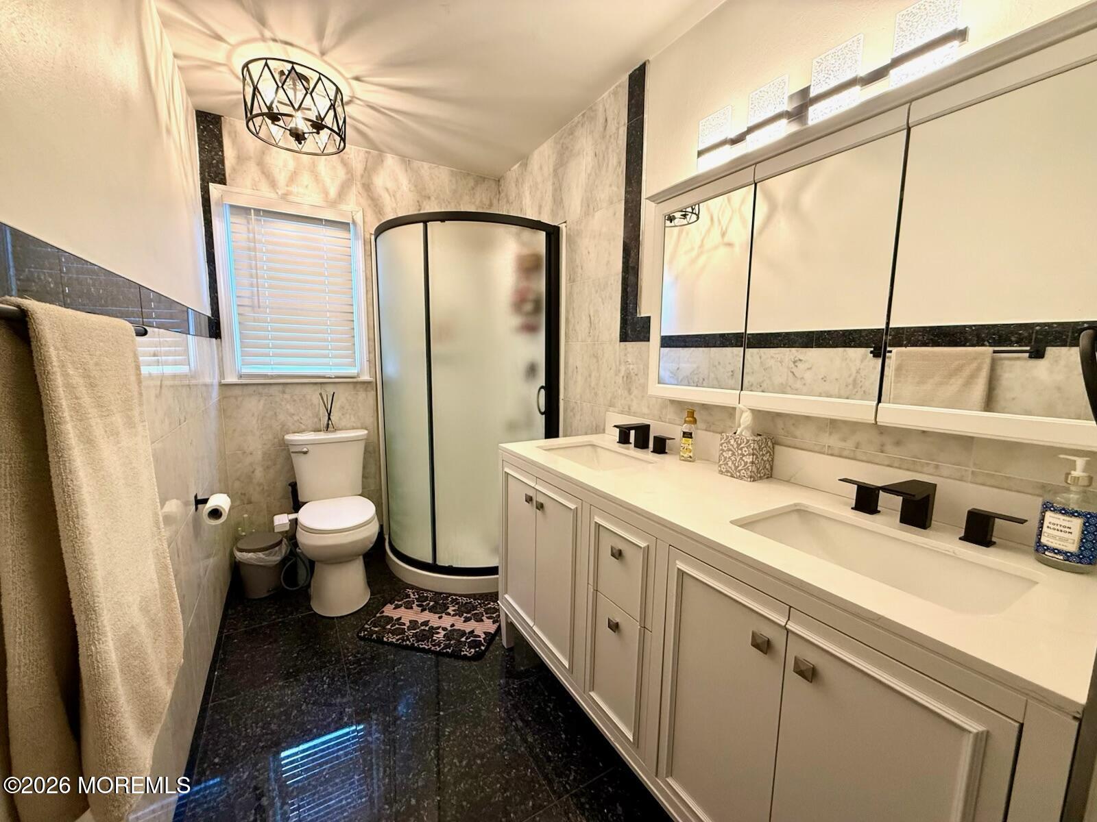 20 Long Road Freehold, NJ 07728 - Photo 10 of 20 a spacious bathroom with a double vanity sink a mirror and a toilet
