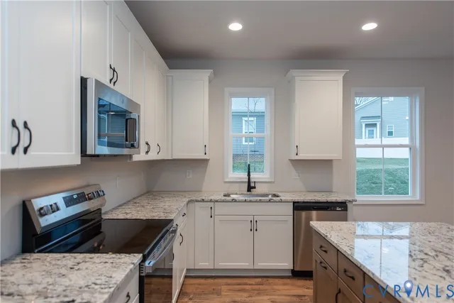 a kitchen that has a sink and a stove in it