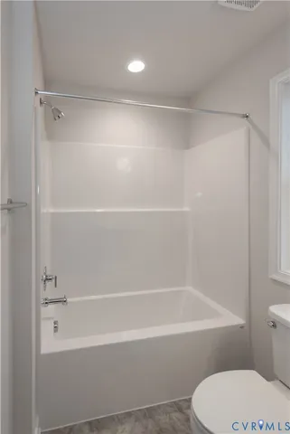 a bathroom with a shower and a toilet