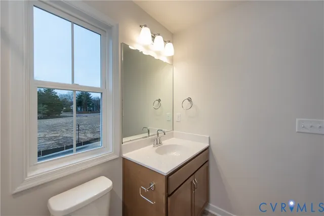 a bathroom with a sink vanity and a mirror