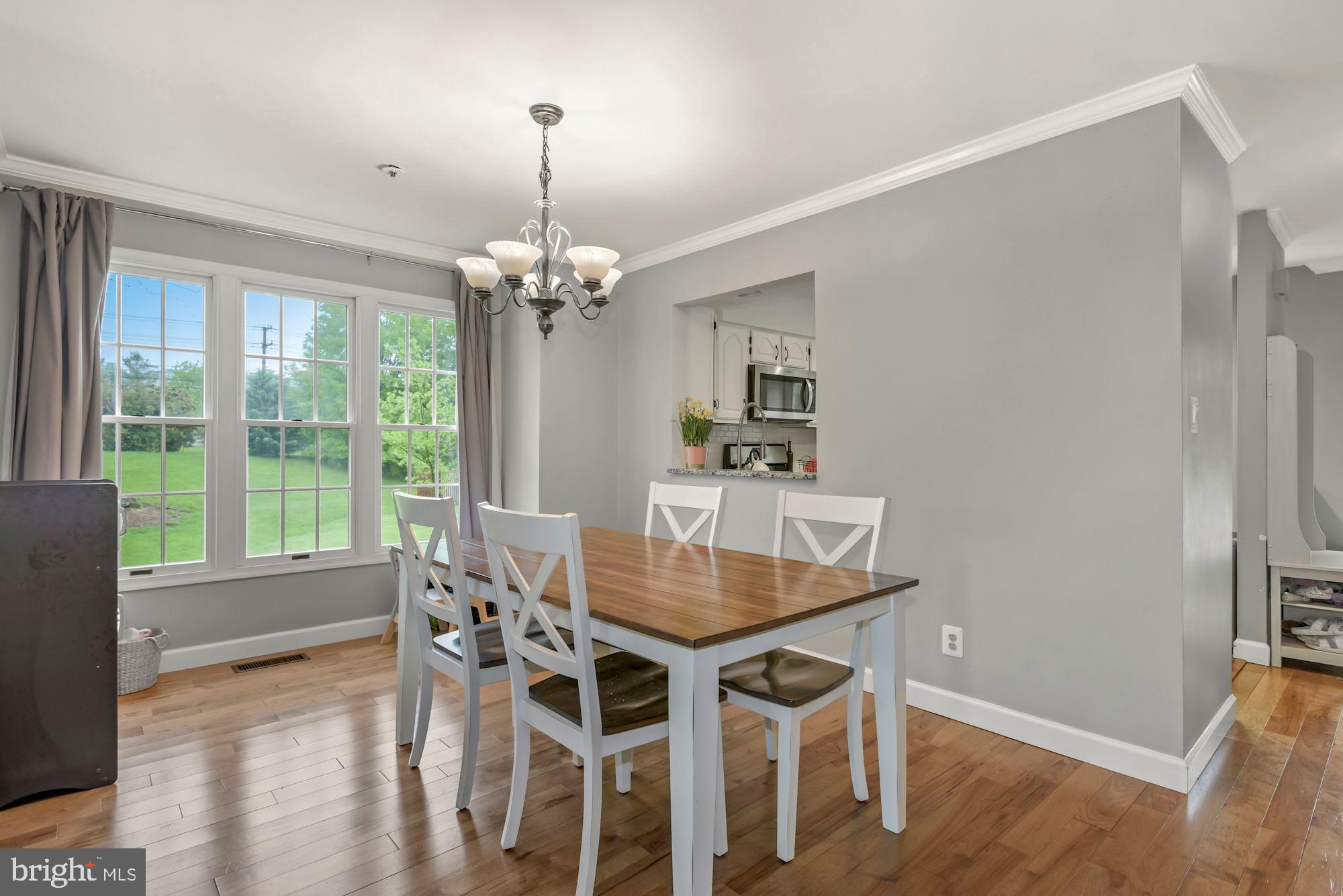 20121 Crew Square Ashburn, VA 20147 - Photo 14 of 36 a view of a dining room with furniture wooden floor and chandelier