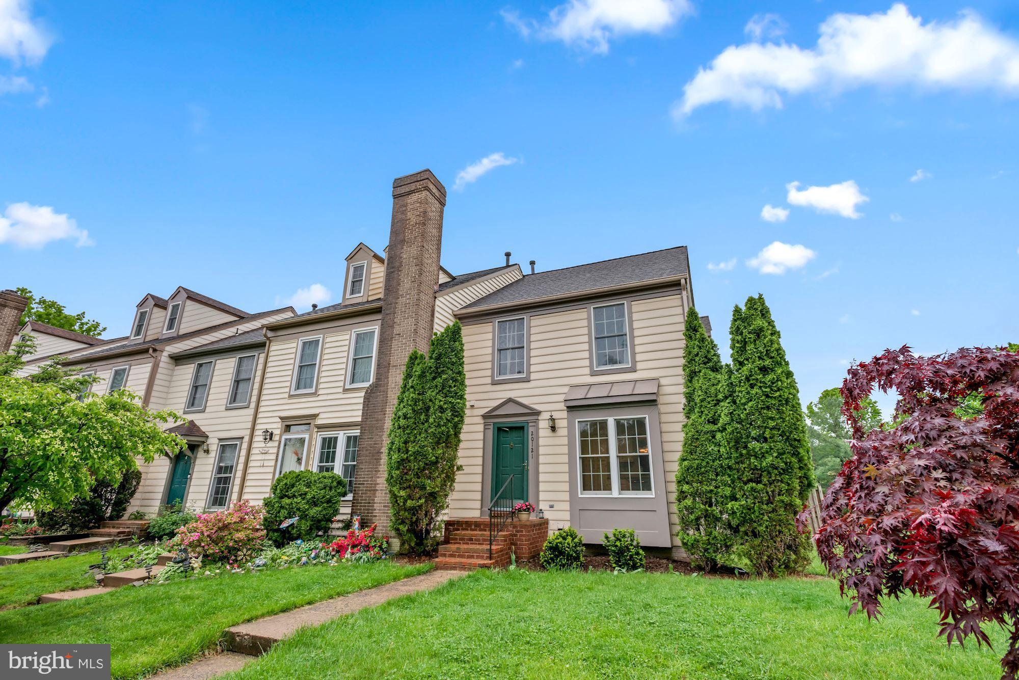 20121 Crew Square Ashburn, VA 20147 - Photo 2 of 36 a front view of a house with a yard and potted plants