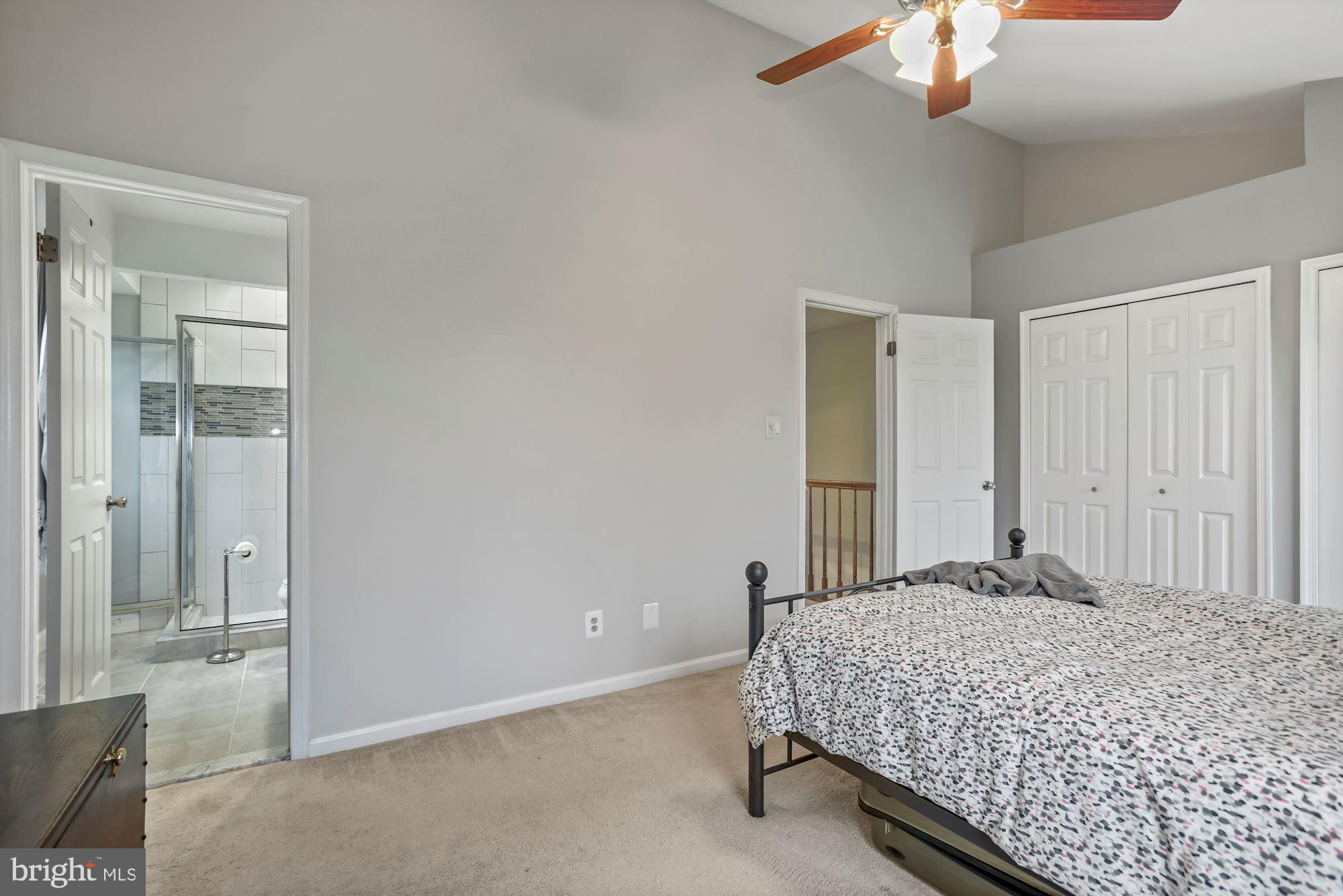 20121 Crew Square Ashburn, VA 20147 - Photo 22 of 36 a bedroom with a bed and a chandelier