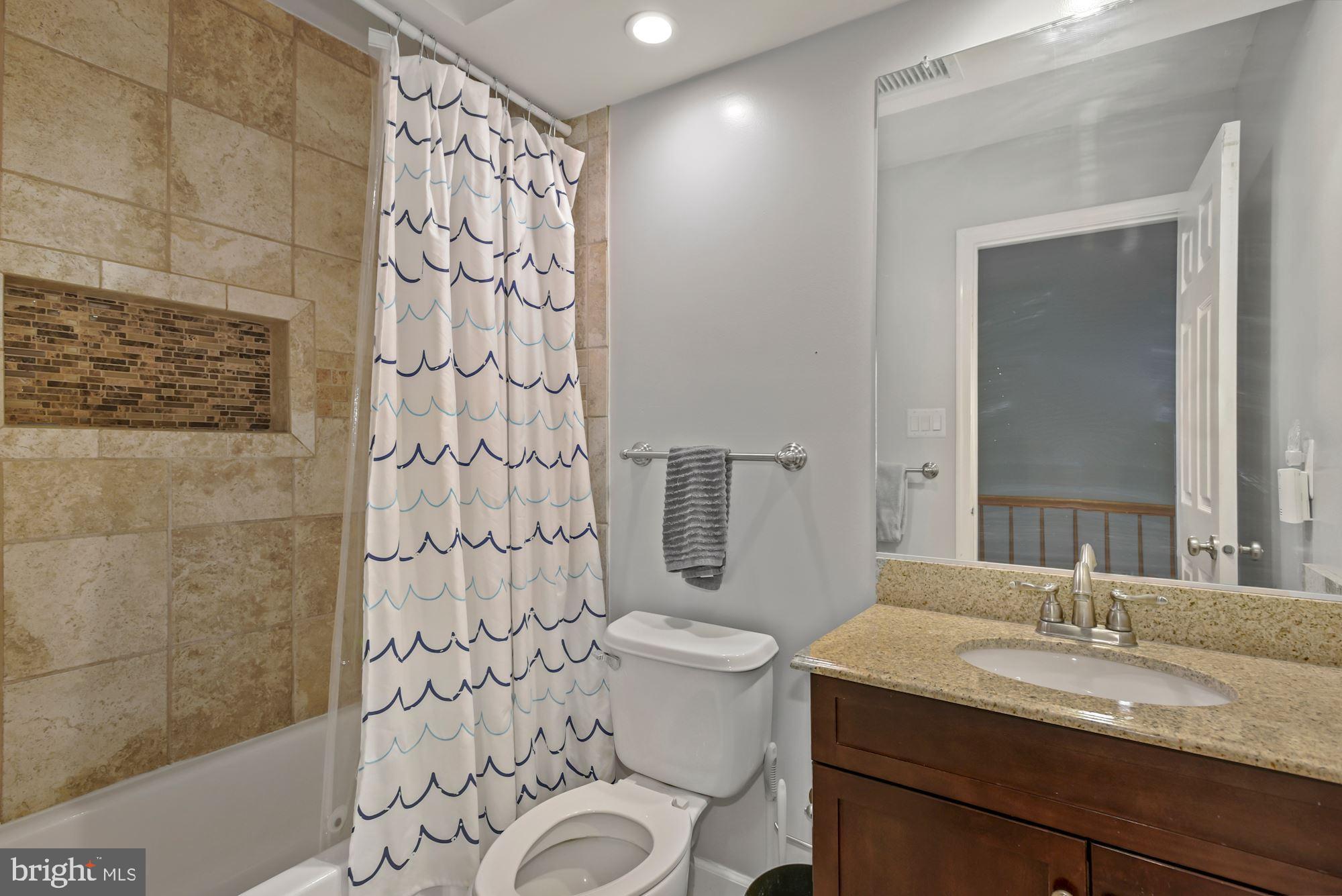 20121 Crew Square Ashburn, VA 20147 - Photo 26 of 36 a bathroom with a granite countertop sink a toilet and a mirror
