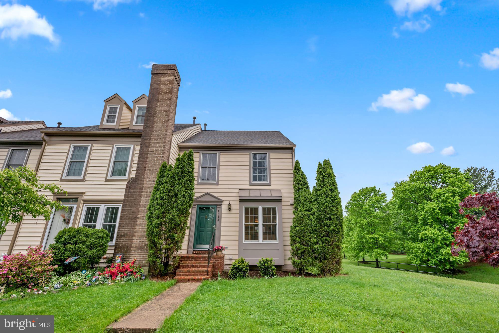 20121 Crew Square Ashburn, VA 20147 - Photo 3 of 36 a front view of a house with a garden and plants