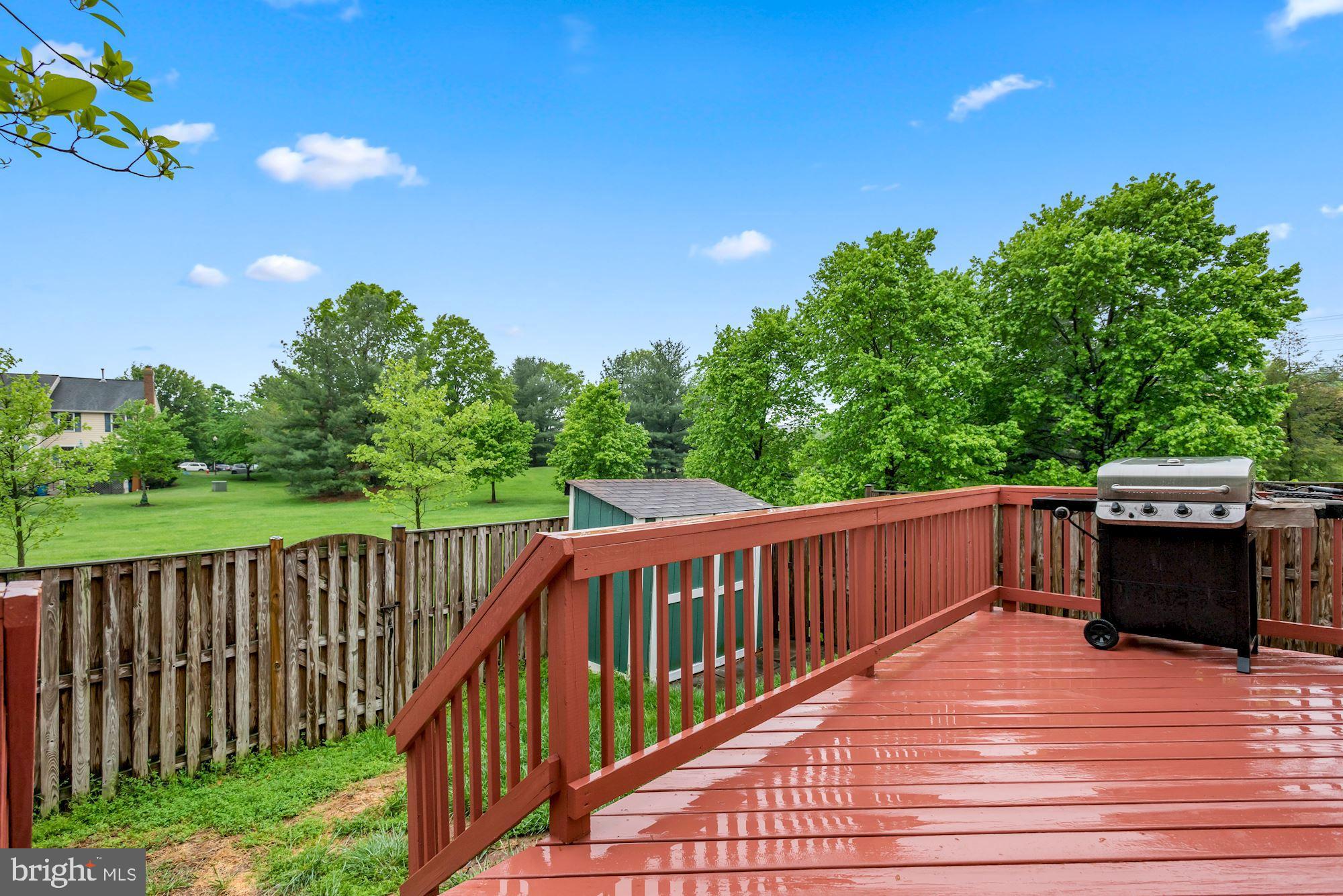 20121 Crew Square Ashburn, VA 20147 - Photo 32 of 36 a view of a wooden deck and a yard