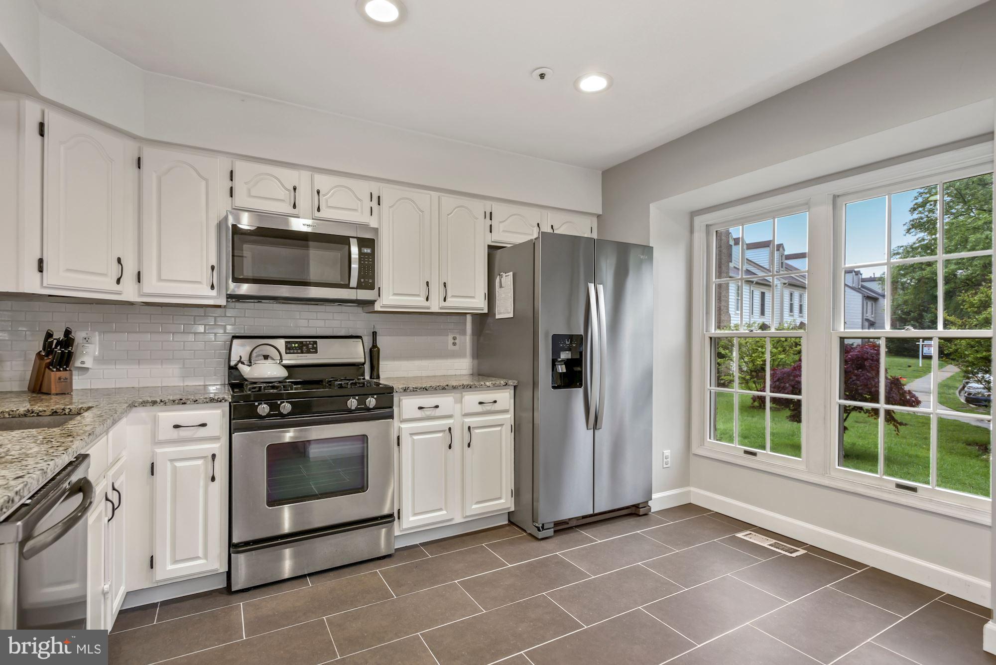 20121 Crew Square Ashburn, VA 20147 - Photo 7 of 36 a kitchen with stainless steel appliances a stove a sink and a refrigerator